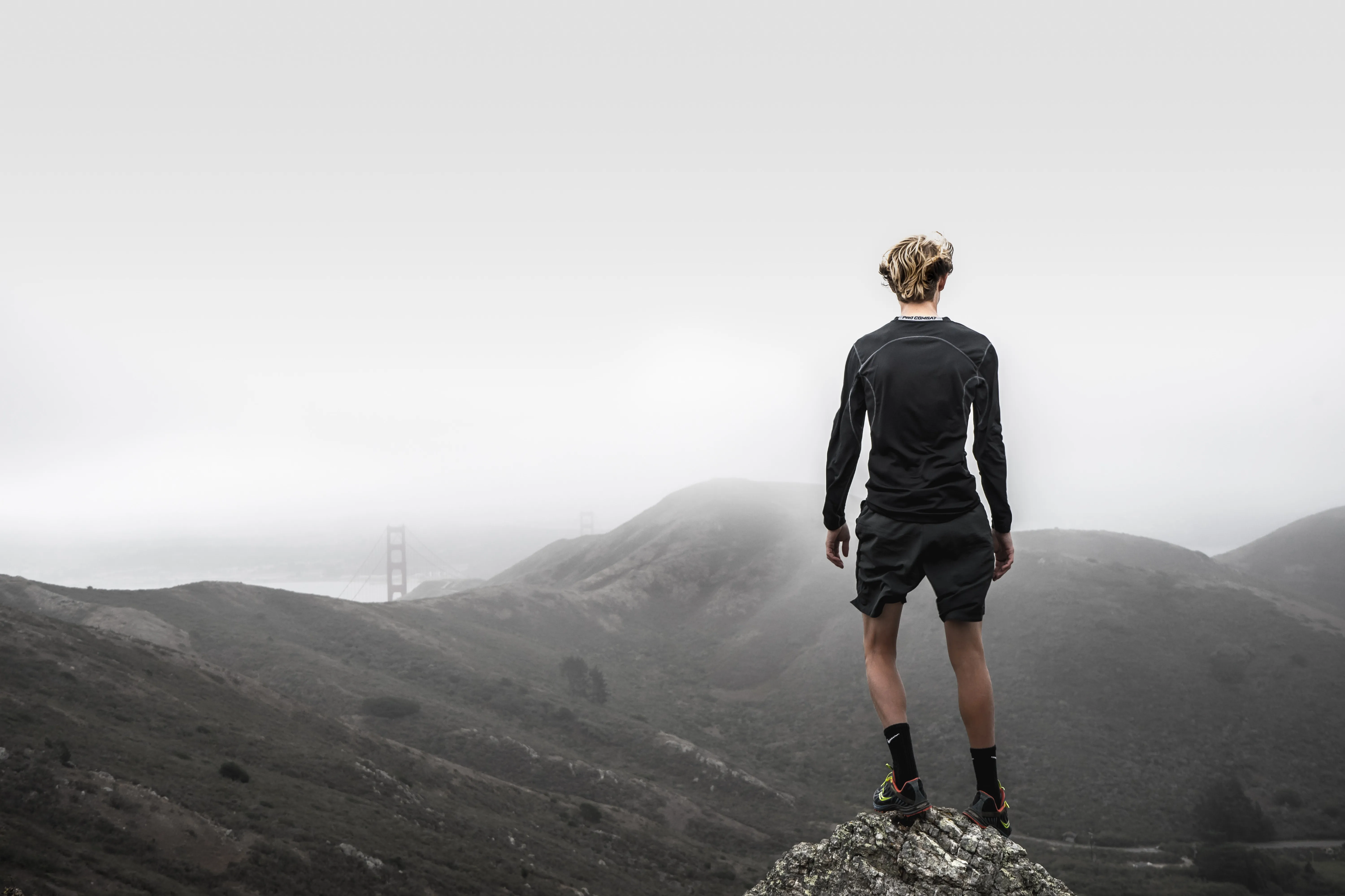 Runner standing atop a mountain during the coolest time of the day
